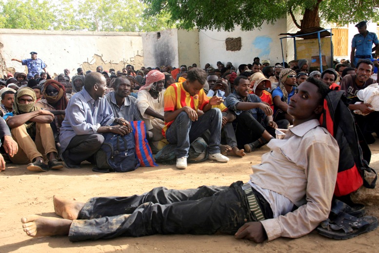 Illegal immigrants who were abandoned by traffickers in a remote desert area wait inside a military base in Dongola town, after being located by Sudanese and Libyan forces, May 3, 2014. The desert area between Sudan and Libya is a major route for illegal immigrants trying to escape Sudan's war-torn regions, with many of them transiting in Libya before trying to flee to Europe across the Mediterranean Sea. REUTERS/Stringer (SUDAN - Tags: CRIME LAW SOCIETY IMMIGRATION CONFLICT TPX IMAGES OF THE DAY) - RTR3NO6T