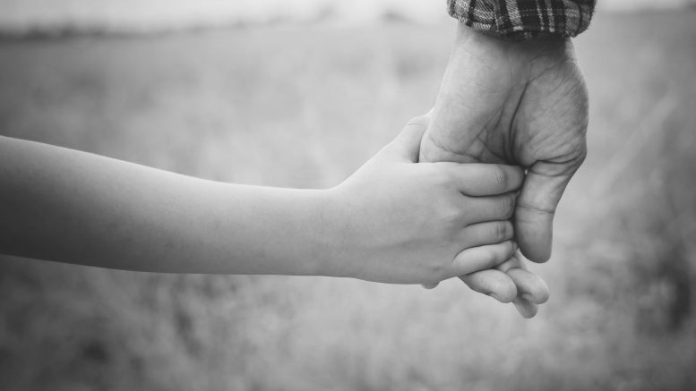 Close up of father holding his daughter hand, so sweet,family ti